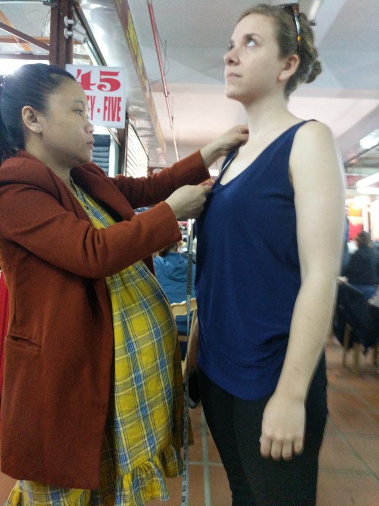 My VERY pregnant tailor sizing me up.